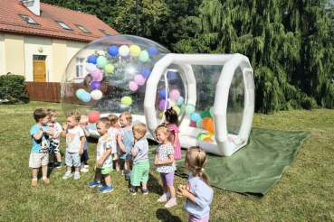 Dzieci wchodzą do przezroczystego balonu